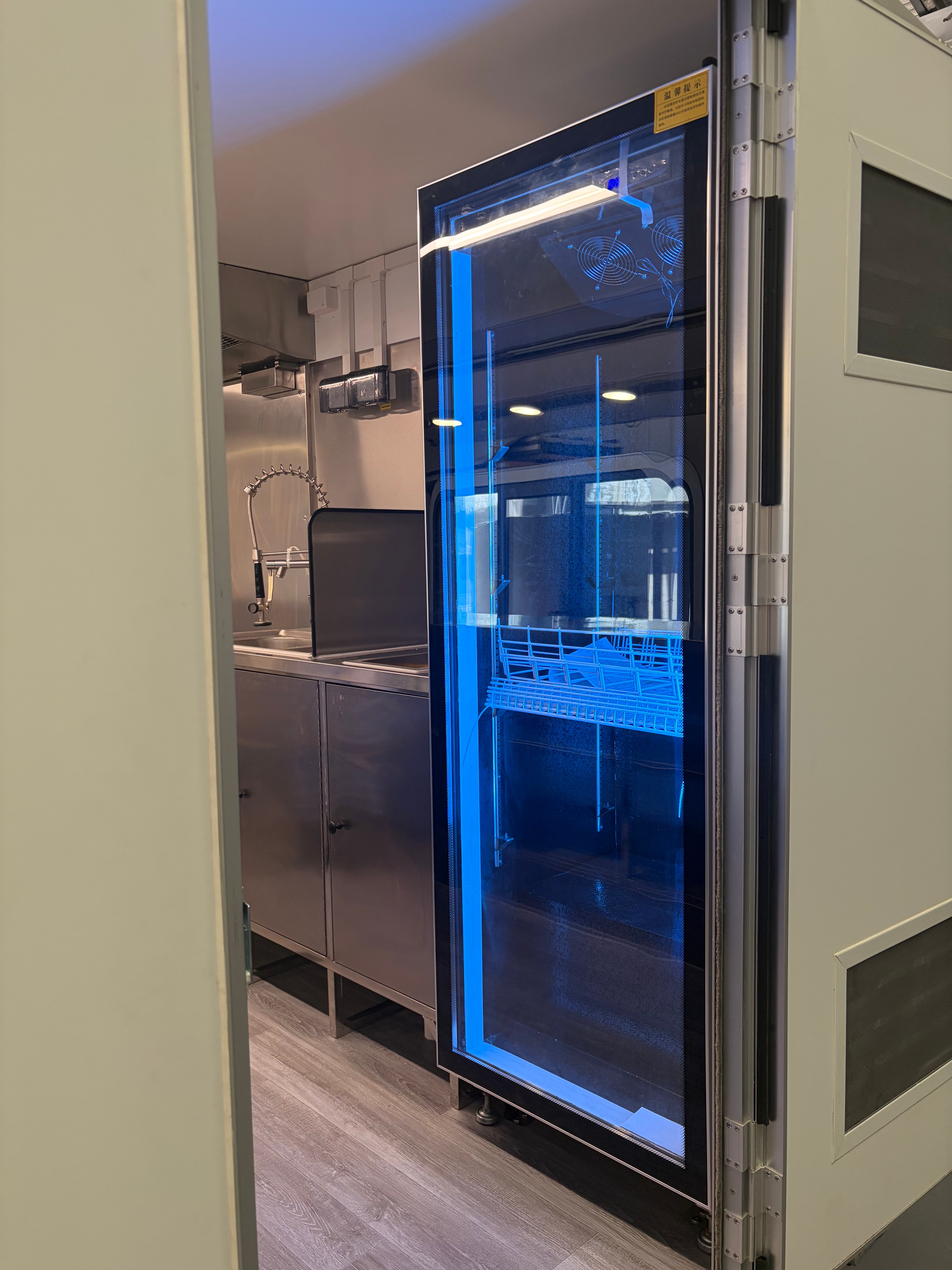 Stainless steel under-counter fridge unit inside food trailer
