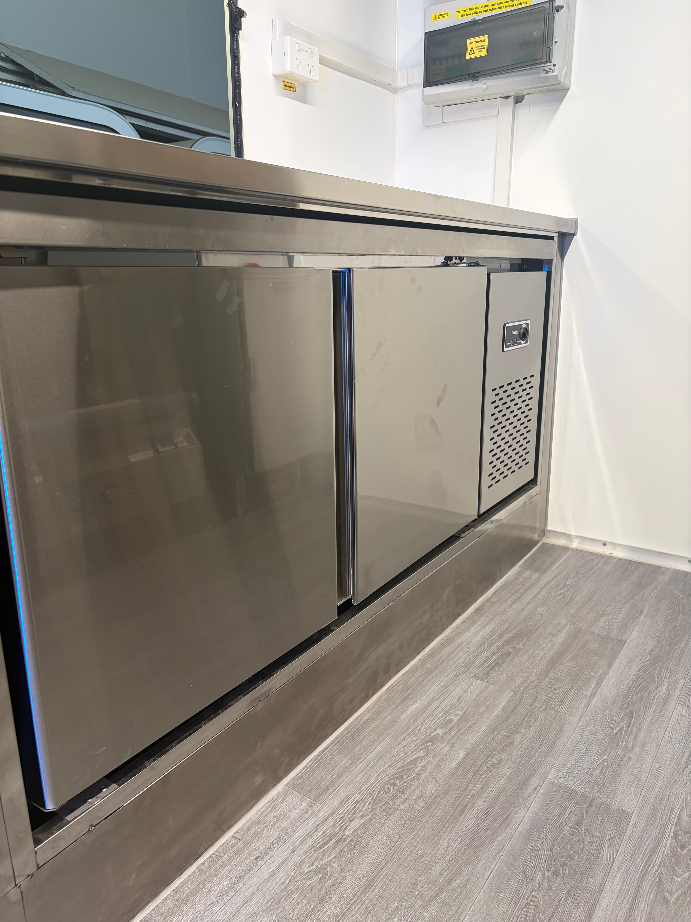 White food trailer with full open kitchen, stainless steel benches and LED strip lighting