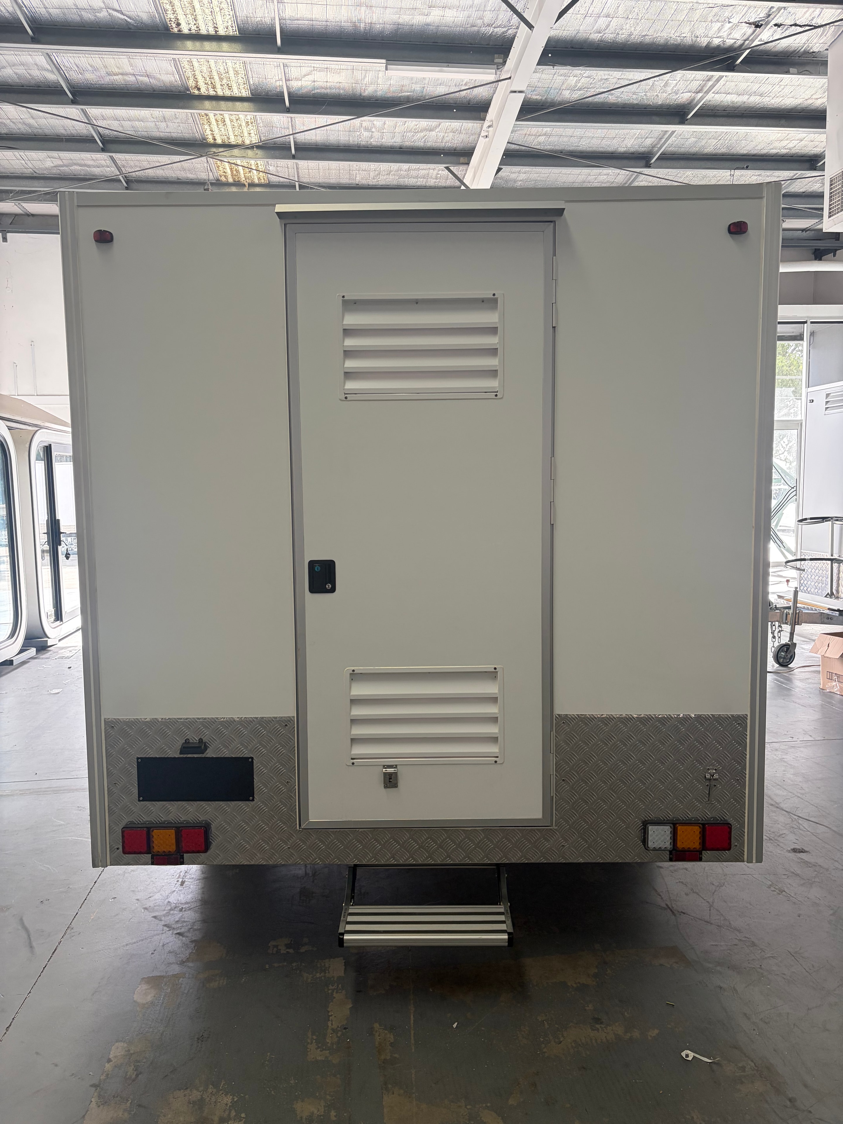 Top-down view of food trailer roof showing hatch doors, LED halo strip and ventilation grille